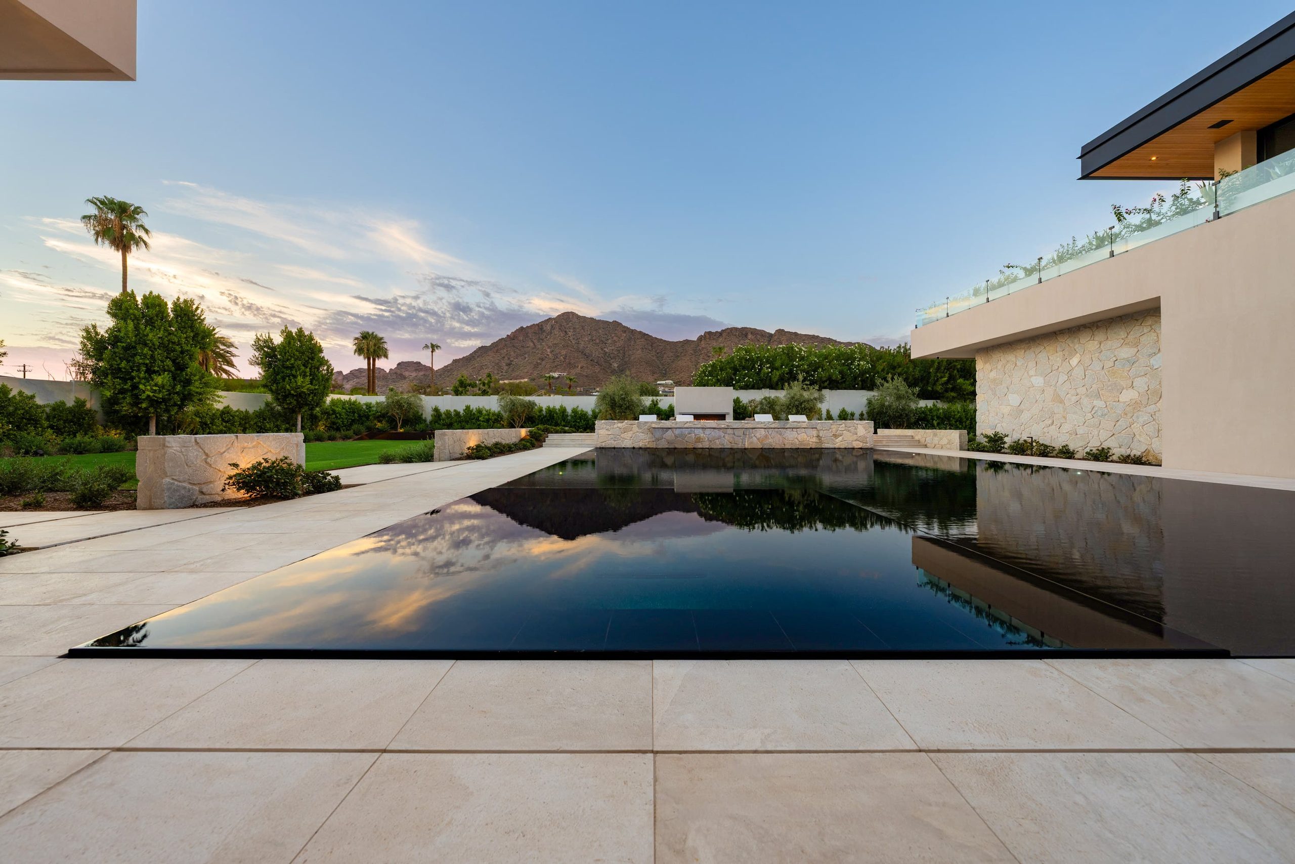 Hoss residence — black reflecting pool with cut-stone walls and Camelback Mountain beyond
