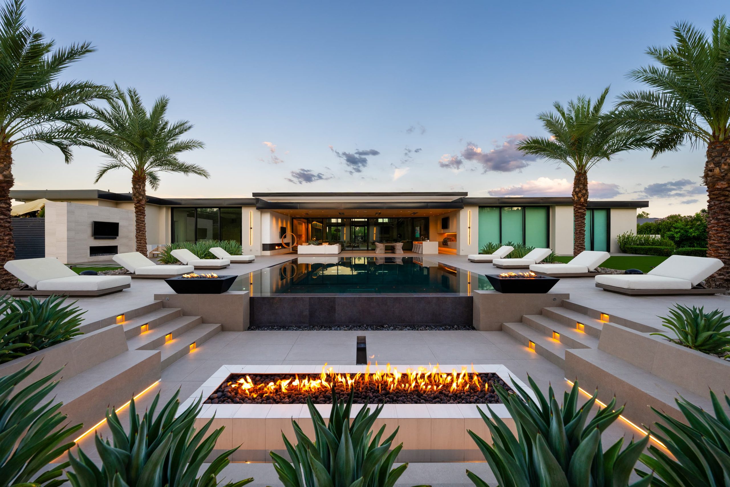 Ianello residence — pool, fire feature and shade pavilion composed under palms