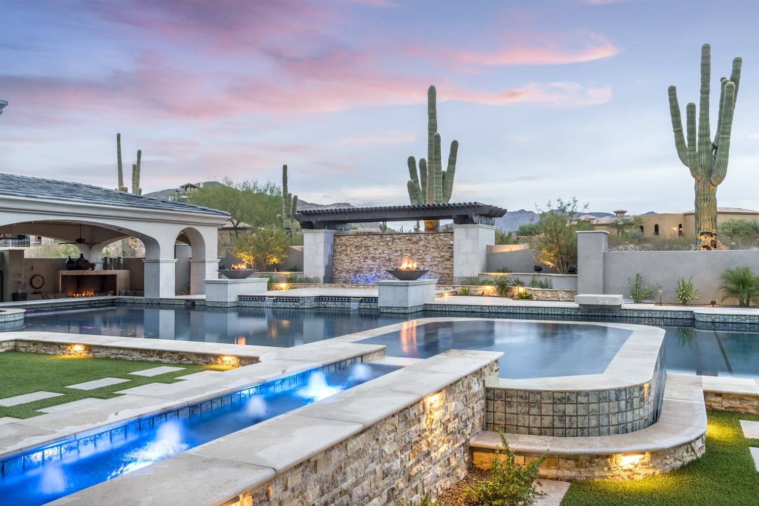 Outdoor kitchen and pavilion beside a pool