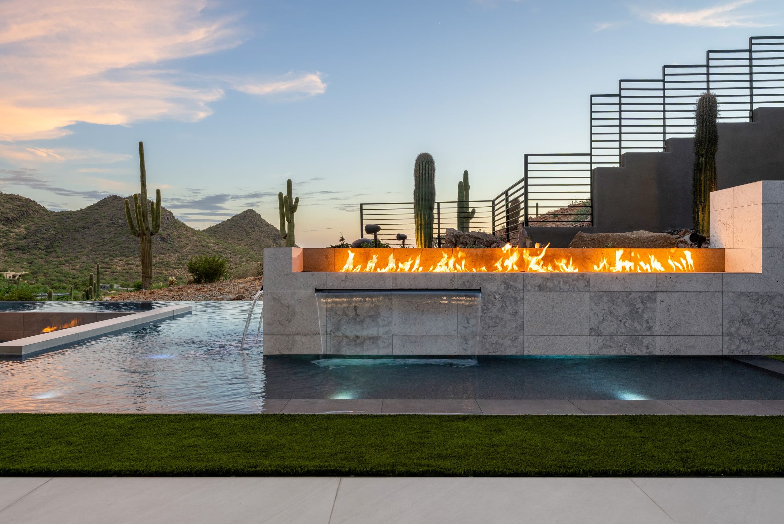 Linear fire feature and stone stair over black water